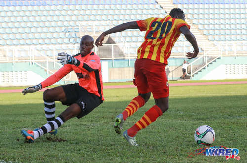 Photo: Point Fortin Civic poacher Jamille Boatswain (right) evades Ma Pau Stars goalkeeper Shane Mattis en route to the opening goal during Pro League action at the Ato Boldon Stadium on 18 September 2016. (Courtesy Sean Morrison/Wired868)