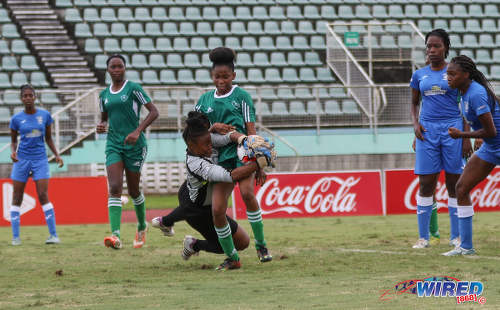 Photo: The Fyzabad Secondary goalkeeper tries to repel an attack from St Augustine Secondary player Jahmealia Jackson during the 2016 Girls National Intercol final at the Mannie Ramjohn Stadium in Marabella on 2 December 2016. (Courtesy Sean Morrison/Wired868)