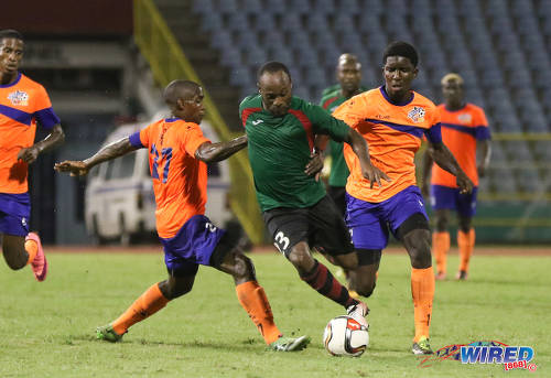 Photo: San Juan Jabloteh attacker Kennedy Hinkson (centre) tries to weave between two Club Sando players during Pro League action at the Hasely Crawford Stadium on 9 December 2016. (Courtesy Sean Morrison/Wired868)