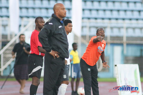 Photo: Naparima College coach Angus Eve (right) makes a point while Presentation College (San Fernando) coach Shawn Cooper looks on during the Big Four final at the Ato Boldon Stadium, Couva on 12 December 2016. (Courtesy Chevaughn Christopher/Wired868)