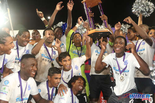 Photo: Naparima College players celebrate with the 2016 Big Four trophy after defeating rivals Presentation College (San Fernando) at the Ato Boldon Stadium in Couva on 12 December 2016. (Courtesy Chevaughn Christopher/Wired868)