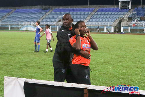 Photo: Naparima College paramedic Kaleisha Delpeche (right) is restrained by the team's goalkeeper coach, Brian James, following a scuffle with Presentation College (San Fernando) paramedic Nathalie Charles after the Big Four final at the Ato Boldon Stadium, Couva on 12 December 2016. (Courtesy Chevaughn Christopher/Wired868)