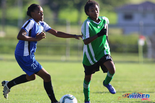 Photo: Penal Secondary attacker Alexcia Ali (right) tries to evade a Fyzabad Anglican Secondary opponent during the Girls South Zone Knockout final at the Mannie Ramjohn Stadium training ground on 2 December 2016. (Courtesy Chevaughn Christopher/Wired868)