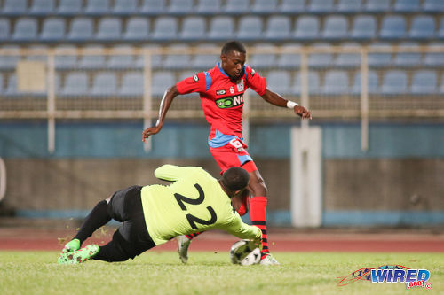 Photo: Police FC attacker Dylon King (right) tries to round Police FC goalkeeper Theon Browne during Pro League action at the Ato Boldon Stadium in Couva on 20 December 2016. (Courtesy Chevaughn Christopher/Wired868)