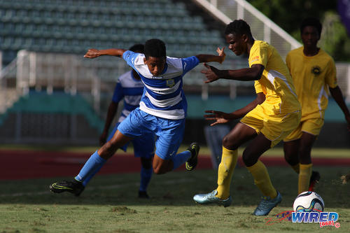 Photo: Presentation College (San Fernando) winger Jordan Riley eludes a Signal Hill Secondary opponent during the National Intercol Semifinals at the Mannie Ramjohn Stadium on 3 December 2016. (Courtesy Chevaughn Christopher/Wired868)