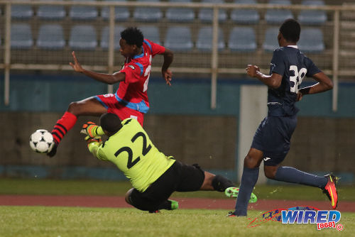 Photo: St Ann's Rangers substitute Kathon St Hillaire (left) tries to find a way around Police FC goalkeeper Theon Browne during Pro League action at the Ato Boldon Stadium in Couva on 20 December 2016. (Courtesy Chevaughn Christopher/Wired868)