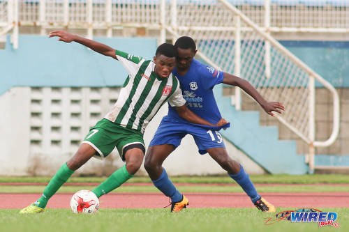 Photo: San Juan North Secondary midfielder Josiah Beard (left) tries to keep the ball from Naparima College defender Shadeon Arthur during the SSFL Big Four semifinals on 9 December 2016 at the Ato Boldon Stadium in Couva. (Courtesy Chevaughn Christopher/Wired868)