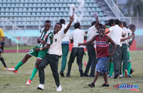 Photo: San Juan North Secondary midfielder Jerome Cyrus (left) is lifted bodily by a schoolmate after their 2016 National Intercol final win over Presentation College (San Fernando) at the Mannie Ramjohn Stadium in Marabella on 2 December 2016. (Courtesy Sean Morrison/Wired868)