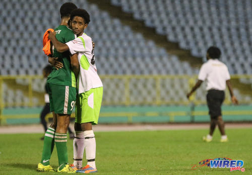 Photo: San Juan North substitute Ibn-Al-Hakim Skinner (right) consoles Trinity College Moka player Michael Quamina after the National Intercol on 30 November 2016 at the Hasely Crawford Stadium, Port of Spain. (Courtesy Sean Morrison/Wired868)