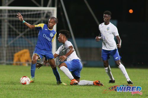 Photo: Shiva Boys Hindu College playmaker Tyrel "Pappy" Emmanuel (left) dances away from a Presentation College (San Fernando) opponent during the SSFL Big Four semifinals on 9 December 2016 at the Ato Boldon Stadium in Couva. (Courtesy Chevaughn Christopher/Wired868)