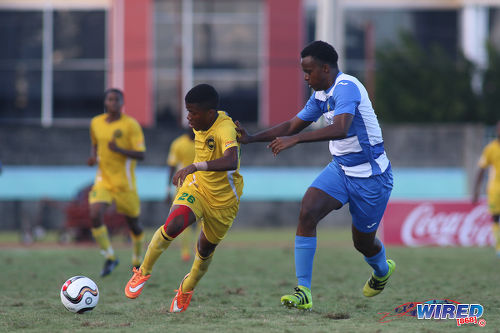 Photo: Signal Hill Secondary forward Ronaldo Samuel (left) takes on Presentation College (San Fernando) defender Matthew Joseph during the National Intercol Semifinals at the Mannie Ramjohn Stadium on 3 December 2016. (Courtesy Chevaughn Christopher/Wired868)