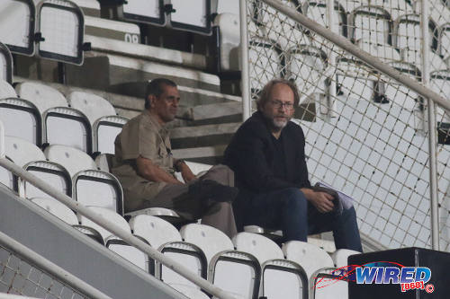 Photo: Trinidad and Tobago head coach Tom Saintfiet (right) and ex-TTFA general secretary Azaad Khan take in a Pro League contest between Central FC and W Connection at the Ato Boldon Stadium in Couva on Monday 12 December 2016. Kenwyne Jones scored a deft winner but was still excluded from the national side. (Courtesy Chevaughn Christopher/Wired868)