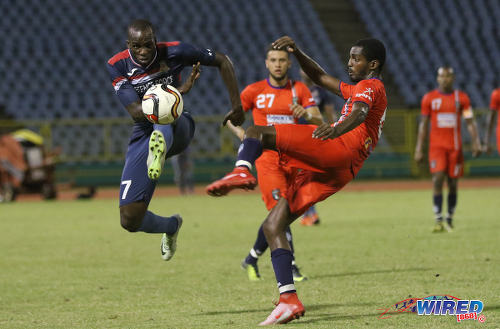 Photo: Defence Force attacker Jamille Boatswain (left) and Morvant Caledonia United defender Taje Commissiong contest the ball during Pro League action at the Hasely Crawford Stadium on 17 January 2017. (Courtesy Sean Morrison/Wired868)