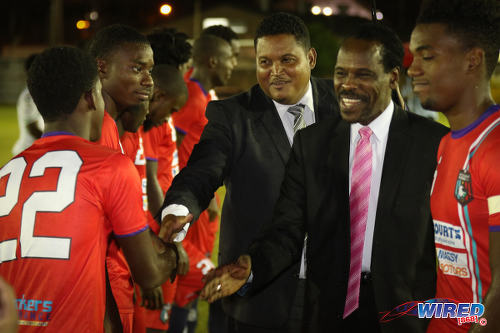 Photo: Sport Minister Darryl Smith (centre) and Minister of Public Utilities Fitzgerald Hinds (second from right) meet players from Morvant Caledonia United before kick off against W Connection at the Hasely Crawford Stadium training ground on 20 January 2017. (Courtesy Sean Morrison/Wired868) 