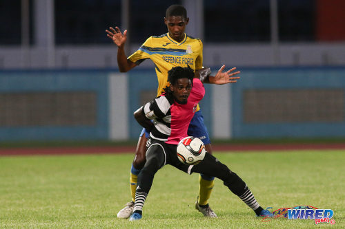 Photo: Central FC forward Jason Marcano (foreground) holds off Defence Force defender Jamali Garcia during Pro League action at the Ato Boldon Stadium, Couva on 24 January 2017. (Courtesy Chevaughn Christopher/Wired868)