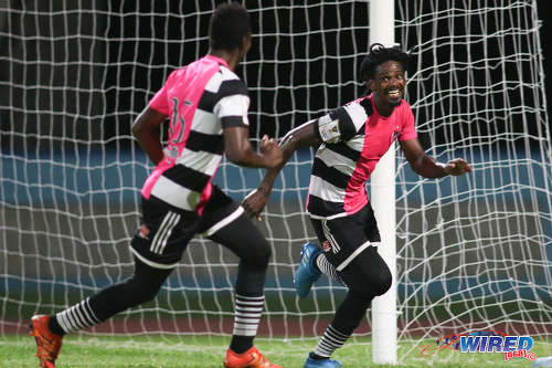 Photo: Central FC forward Jason Marcano (right) celebrates his late penalty against Defence Force at the Ato Boldon Stadium, Couva on 24 January 2017. Central won 2-1 to return to the top of the standings. (Courtesy Chevaughn Christopher/Wired868)