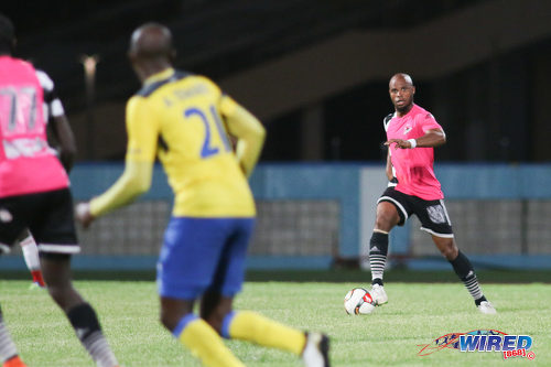 Photo: Central FC defender Julius James (right) looks for passing options during Pro League action against Defence Force at the Ato Boldon Stadium, Couva on 24 January 2017. (Courtesy Chevaughn Christopher/Wired868)