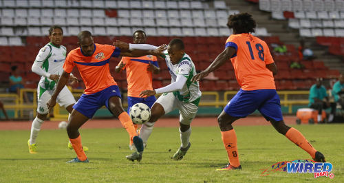 Photo: W Connection midfielder Briel Thomas (centre) and Club Sando defender Leslie Joel Russell (left) contest the ball during Pro League action on 10 January 2017 at the Hasely Crawford Stadium in Port of Spain. (Courtesy Sean Morrison/Wired868)