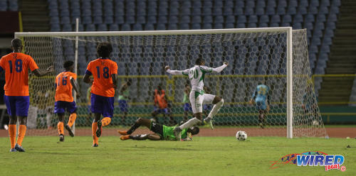 Photo: W Connection striker Jamal Charles (right) dances around Club Sando goalkeeper Kelvin Henry during Pro League action on 10 January 2017 at the Hasely Crawford Stadium in Port of Spain. (Courtesy Sean Morrison/Wired868)