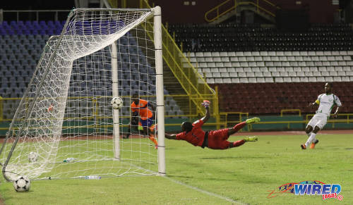 Photo: Club Sando attacker Keron Cornwall (left) buries the ball past W Connection custodian Terrence Clarke during Pro League action on 10 January 2017 at the Hasely Crawford Stadium in Port of Spain. (Courtesy Sean Morrison/Wired868)