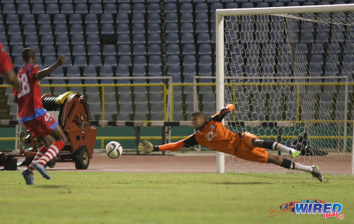 Photo: St Ann's Rangers goalkeeper Christopher Biggette (right) produced a low, flying save during Pro League action against W Connection at the Hasely Crawford Stadium on 17 January 2017. (Courtesy Sean Morrison/Wired868)