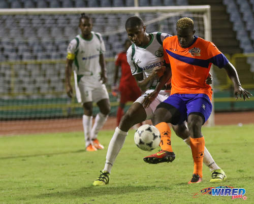 Photo: Club Sando forward Akeem Roach (right) is watched closely by W Connection defender Jelani Peters during Pro League action on 10 January 2017 at the Hasely Crawford Stadium in Port of Spain. (Courtesy Sean Morrison/Wired868)