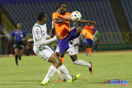 Photo: Club Sando midfielder Kemuel Rivers (right) tries to tame an awkwardly bouncing ball during Pro League action against W Connection on 10 January 2017 at the Hasely Crawford Stadium in Port of Spain. (Courtesy Sean Morrison/Wired868)