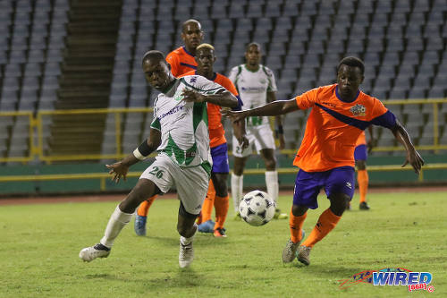 Photo: Club Sando midfielder Kemuel Rivers (right) and W Connection winger Shaquille Bertrand chase a loose ball during Pro League action on 10 January 2017 at the Hasely Crawford Stadium in Port of Spain. (Courtesy Sean Morrison/Wired868)