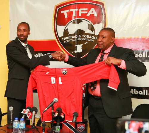 Photo: Trinidad and Tobago Football Association (TTFA) president David John-Williams (right) makes a ceremonial gesture to his new Men's National Senior Team head coach Dennis Lawrence at the TTFA headquarters on 30 January 2017. (Copyright Allan V Crane/TTFA)