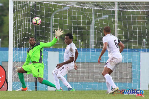 Photo: Trinidad and Tobago goalkeeper Adrian Foncette (left) reaches for the ball while defenders Maurice Ford (centre) and Radanfah Abu Bakr look on during 2017 Gold Cup playoff action against Haiti at the Ato Boldon Stadium in Couva. (Courtesy Chevaughn Christopher/Wired868)