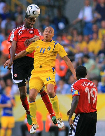 Photo: Trinidad and Tobago defender Dennis Lawrence (left) wins a header from Sweden forward Henrik Larsson during the Germany 2006 World Cup at the Dortmund Stadium. (Copyright AFP 2017)