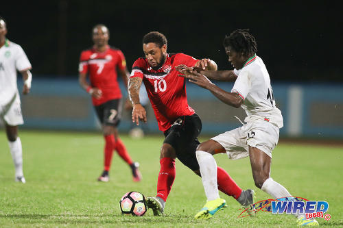 Photo: Trinidad and Tobago substitute Shahdon Winchester (centre) takes on Suriname right back Miquel Darson during 2017 Gold Cup playoff action at the Ato Boldon Stadium, Couva on 4 January 2017. (Courtesy Chevaughn Christopher/Wired868)