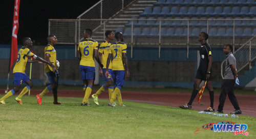 Photo: Defence Force players (from right) Jamille Boatswain, Justin Garcia, Rodell Elcock, Chris Durity and Jerwyn Balthazar remonstrate with referee's assistant Caleb Wales (far right) during the Pro Bowl final at the Ato Boldon Stadium on 19 February 2017. Defence Force edged Central FC 5-3 on kicks from the penalty mark after a 2-2 draw. (Courtesy Sean Morrison/Wired868)