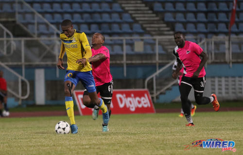 Photo: Defence Force attacker Hashim Arcia (left) heads to goal while Central FC midfielder Leston Paul (centre) tries to hang on and defender Keion Goodridge looks on in the Pro Bowl final on 19 February 2017 at the Ato Boldon Stadium. Defence Force won 5-3 on kicks from the penalty mark after a 2-2 draw. (Courtesy Sean Morrison/Wired868)