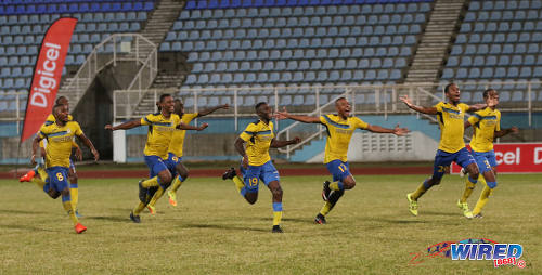 Photo: Defence Force players (from right) Jamali Garcia, Justin Garcia, Curtis Gonzales, Thurlani George, Jerwyn Balthazar, Rodell Elcock and Chris Durity react to teammate Devorn Jorsling's successful penalty kick during the Pro Bowl final at the Ato Boldon Stadium on 19 February 2017. Defence Force edged Central FC 5-3 on kicks from the penalty mark after a 2-2 draw. (Courtesy Sean Morrison/Wired868)