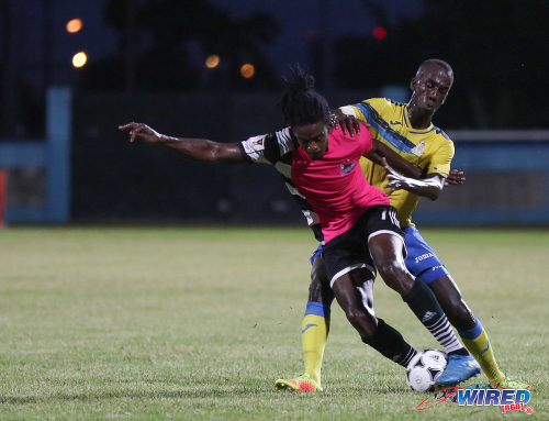 Photo: Central FC attacker Jason Marcano (left) tries to wriggle clear of Defence Force captain Jerwyn Balthazar during the Pro Bowl final on 19 February 2017 at the Ato Boldon Stadium. Defence Force won 5-3 on kicks from the penalty mark after a 2-2 draw. (Courtesy Sean Morrison/Wired868)