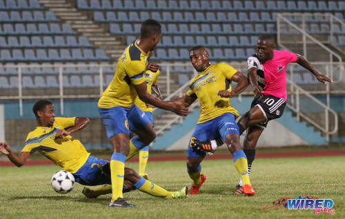 Photo: Central FC playmaker Keron Cummings (right) is closed down by Defence Force players (from right) Chris Durity, Rodell Elcock and Justin Garcia during the Pro Bowl final at the Ato Boldon Stadium on 19 February 2017. Defence Force won 5-3 on kicks from the penalty mark after a 2-2 draw. (Courtesy Sean Morrison/Wired868)