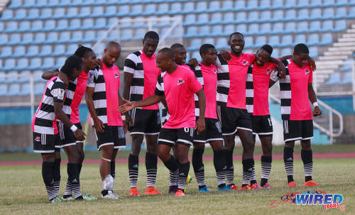 Photo: Centrala FC midfielder Leston Paul (centre) is congratulated by teammates after his successful penalty against Club Sando during the Pro Bowl semifinals at the Ato Boldon Stadium on 12 February 2017. Central won 5-4 via kicks from the penalty mark. (Courtesy Sean Morrison/Wired868)