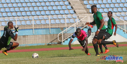 Photo: Central FC attacker Rundell Winchester (centre) sends a diving header past San Juan Jabloteh goalkeeper Javon Sample (left) during Pro League action at the Ato Boldon Stadium in Couva on 5 February 2017. Looking on are Jabloteh players Nathan Lewis (far right) and Josiah Trimmingham. (Courtesy Sean Morrison/Wired868)