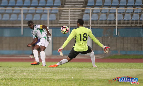 Photo: W Connection captain Hughtun Hector (left) tries to beat Police FC goalkeeper Adrian Foncette during Digicel Pro Bowl quarterfinal action at the Ato Boldon Stadium in Couva on 8 February 2017. (Courtesy Sean Morrison/Wired868)