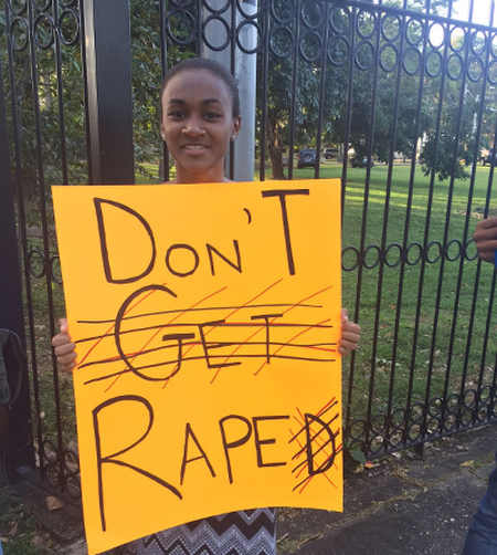 Photo: A protestor displays a slogan outside the house of Prime Minister Dr Keith Rowley on 11 February 2017.