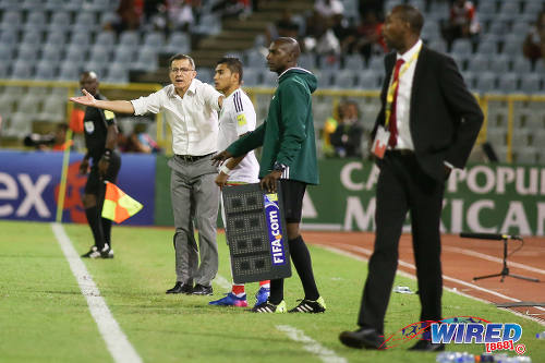 Photo: Mexico coach Juan Carlos Osorio (left) complains to the fourth official while Trinidad and Tobago coach Dennis Lawrence (right) follows the action during Russia 2018 World Cup qualifying action at the Hasely Crawford Stadium on 28 March 2017. Mexico won 1-0. (Courtesy Chevaughn Christopher/Wired868)