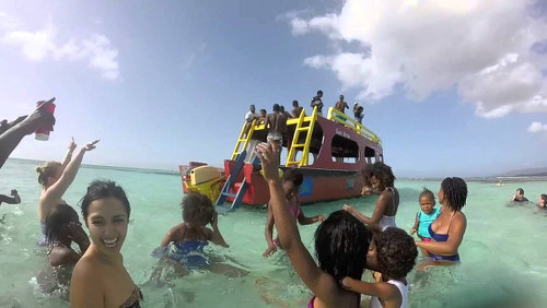 Photo: Visitors wait for a flat bottom boat to take them to the Buccoo Reef.