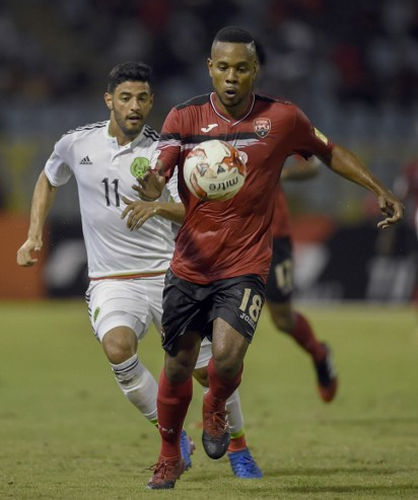 Photo: Trinidad and Tobago defender Curtis Gonzales (right) keeps the ball from Mexico attacker Carlos Vela during their Russia 2018 FIFA World Cup qualifying action at the Hasely Crawford Stadium in Port of Spain on 28 March 2017. (Copyright AFP 2017/Alfredo Estrella)