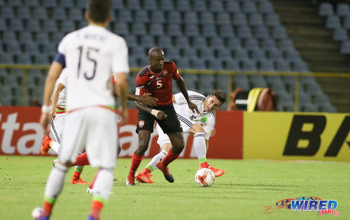 Photo: Trinidad and Tobago defender Daneil Cyrus (centre) advances with the ball while Mexico midfielder Hector Herrera looks on during Russia 2018 World Cup qualifying action at the Hasely Crawford Stadium on 28 March 2017. Mexico won 1-0. (Courtesy Chevaughn Christopher/Wired868)