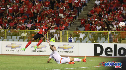 Photo: Trinidad and Tobago midfielder Joevin Jones (left) blasts the ball into the back of the net while Mexico defender Carlos Salcedo looks on during Russia 2018 World Cup qualifying action at the Hasely Crawford Stadium on 28 March 2017. Jones' item was incorrectly ruled out for offside as T&T lost 1-0 to Mexico. (Courtesy Sean Morrison/Wired868)