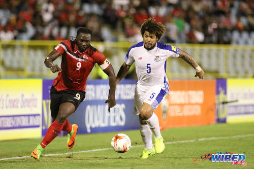 Photo: Trinidad and Tobago forward Kenwyne Jones (left) outruns Panama central defender Roman Torres during 2018 World Cup qualifying action at the Hasely Crawford Stadium on 24 March 2017. (Courtesy Chevaughn Christopher/Wired868)