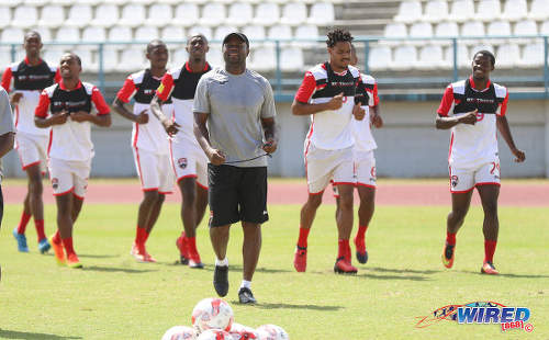 Photo: Trinidad and Tobago National Senior Team assistant coach Stern John (foreground) leads the squad in training at the Larry Gomes Stadium in Malabar on 8 March 2017. (Courtesy Sean Morrison/Wired868)