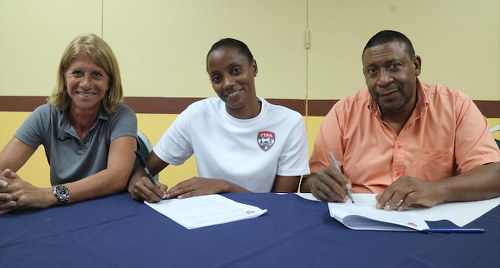 Photo: Trinidad and Tobago Women's National Senior Team captain Tasha St Louis (centre) signs a one year monthly retainer contract alongside TTFA president David John-Williams (right) and head coach Carolina Morace on 27 March 2017. (Copyright TTFA Media)