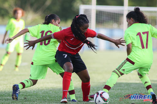 Photo: Trinidad and Tobago Women's National Senior Team midfielder Dernelle Mascall (centre) tries to hold off Venezuela players Maikerlin Astudillo (left) and Yeiny Rosal during international friendly action at the Ato Boldon Stadium in Couva on 26 May 2017. (Courtesy Chevaughn Christopher/Wired868)